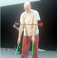 Steve the Juggler performing the arm roll devilstick trick